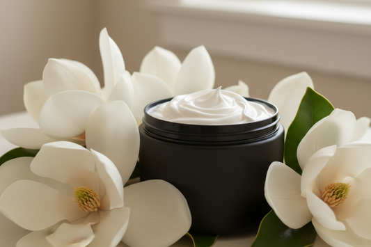 white body butter cream in a black plastic jar with magnolia flowers. no labels